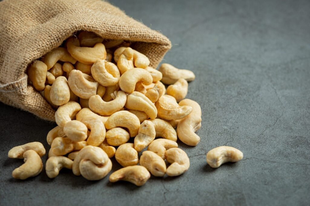 raw-cashews-nuts-bag-dark-background-scaled (1)